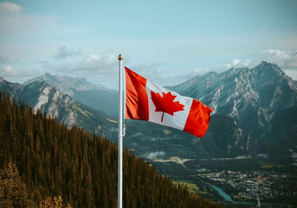 Canadian flag and mountains for Express Entry OINP and permanent residence planning