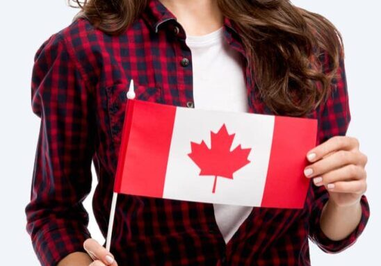 Canadian immigration client holding a Canadian flag for Russian Hebrew and English consultation support